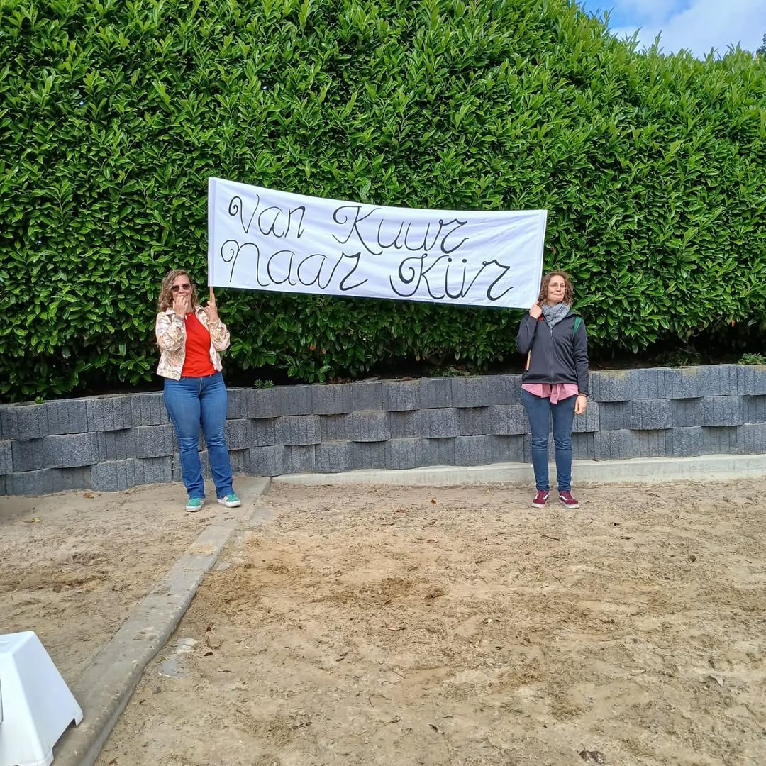 Yvanka en een ander houden het spandoek Van Kuur naar Kür